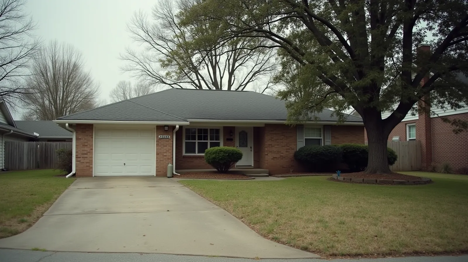 Brick ranch house in a suburban Tennessee neighborhood on an overcast afternoon